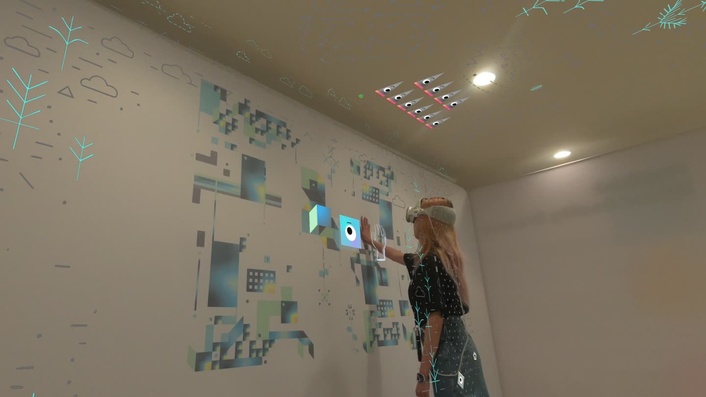 Seen through a headset: mixed-reality shapes anchored to the wall of a room in Cupertino